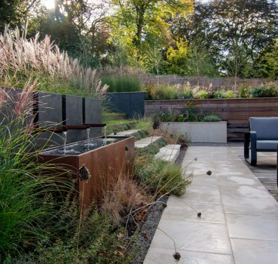 Contemporary, terraced and naturalistic garden with corten water feature, Warrington